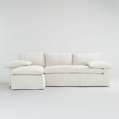 a white couch with pillows on it