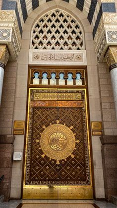 the entrance to an ornate building with gold and black decorations