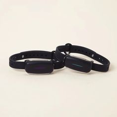 two black bracelets sitting next to each other