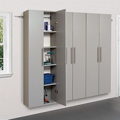 a room with some cabinets in it and a blue bin on the floor next to them