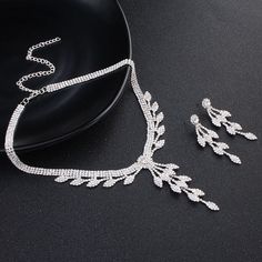 Product information: Chain material: alloy/silver plated/gold plated Pattern: plant flowers Pendant material: water diamond Color: silver Inlay material: alloy inlay artificial gem/semi-gem Packing list: 1 pair x earrings ， necklaces*1 Silver Alloy Rhinestone Necklace For Wedding, Silver Rhinestone Necklace For Wedding, Gold Rhinestone Alloy Jewelry Sets, Wedding Jewelry Sets With Rhinestones, Silver Alloy Rhinestone Necklace, Elegant Alloy Jewelry With Sparkling Stones, Silver Rhinestone Necklace In Alloy, Wedding Rhinestone Metal Jewelry Sets, Rhinestone Metal Jewelry Sets For Weddings