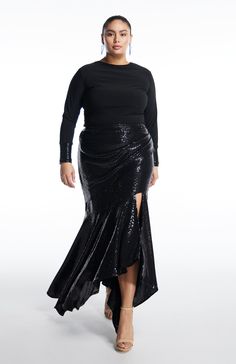 Styling: Euterpe is a captivating long sequin skirt that guarantees you will command attention. The front drape elegantly enhances the hips and adds drama. The asymmetrical flared lower panels create stunning movement as you walk. This classic piece is a must-have for your wardrobe and will be a beloved addition for seasons. Fully lined and featuring a center-back zipper opening, Euterpe is a timeless statement piece. The Fit: The fit is slim, but the fabric has a lot of stretch and is forgiving Long Sequin Skirt Outfit, Plus Size Sequin Skirt, Long Sequin Skirt, Sequin Skirt Outfit, Sequin Skirt Long, Long Drapes, Plus Size Designers, Silver Sparkle, Black Sparkle