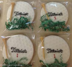 four decorated cookies in plastic wrappers with golf balls and tees written on them