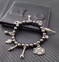 These cute and classy custom Beaded Car Part Charm Bracelets are trendy and will surely make a statement! Create a unique bracelet that shows off your unique style! This bracelet can fit up to 15 charms. Charm Options: - Option#1: Fully Custom Bracelet (Plain Bracelet/ No Charms) Please order your charms for this option here: Charm Listing - Option#2: 15 Random Charms - Option#3: Driver’s Bracelet Turbo, Car Keys & Remote, Steering Wheel, Gear, Stoplight, Wrench, Mini Racecar - Option#4: Mechanic’s Special Wrench, Crescent Wrench, Hex Nut, Spark Plug, Heart Gear, Piston, Screwdriver - Option#5: Track Edition Racing Seat, Turbo, Racing Flag, Wheel / Tire, Mini Racecar, Stoplight, Wrench - Option#6: Rotary Lover Rotary, Steering Wheel, Car Keys & Remote, Mini Racecar, Gear, Wrench, Hex Nut T Crescent Wrench, Plain Bracelet, Bike Jewelry, Racing Flag, Turbo Car, Custom Bracelet, Hex Nut, Stop Light, Unique Bracelets