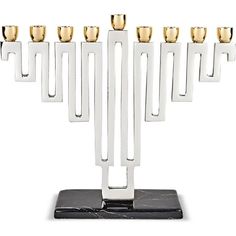 a menorah with five candles on it and black marble base, in front of a white background