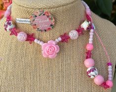 This beautiful pink beaded necklace set is perfect for adding a touch of girly glam to any outfit. The set includes a long necklace with a variety of pink beads, including pink glass beads, pink acrylic beads, and pink seed beads. A sparkling pink star charm and a delicate rose charm add a touch of whimsy to the design. The necklace is finished with a lobster clasp closure. The set also includes a shorter necklace with pink beads and a magnetic clasp closure. Adjustable Colorful Beads Necklace For Valentine's Day, Valentine's Day Gift Pink Beaded Necklaces, Valentine's Day Pink Adjustable Necklace, Adjustable Beaded Necklaces For Valentine's Day, Handmade Pink Beaded Necklaces For Valentine's Day, Pink Handmade Beaded Necklace For Valentine's Day, Pink Beaded Necklace For Valentine's Day, Pink Beaded Chain Jewelry For Valentine's Day, Pink Bohemian Jewelry For Valentine's Day