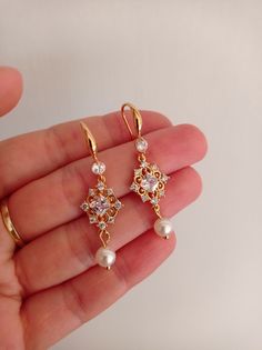 These pearl dangle earrings for brides are perfect for a bling wedding theme. Gorgeous pearl bridal earrings with beautiful pearls in unique design. It looks beautiful and attractive. You will love it.  Available: gold with ivory or white pearls  Please read my policies before purchase: https://www.etsy.com/shop/SilkPearlDesign#policies Elegant Pearl Dangle Earrings, Elegant Gold Crystal Earrings For Anniversary, Elegant Pearl Chandelier Earrings As A Gift, Graceful Dangle Bridal Earrings For Gift, Exquisite Gold Cubic Zirconia Bridal Earrings, Elegant Pearl Earrings For Wedding, Delicate Gold Pearl Chandelier Earrings, Elegant Gold Pearl Chandelier Earrings, Gold Pearl Chandelier Earrings Delicate Style