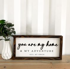 a wooden sign that says you are my home and my adventure all at once