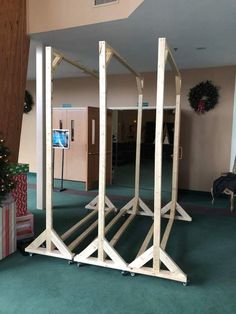 there is a wooden structure in the middle of a room with christmas decorations on the floor