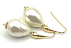 A pair of elegant earrings crafted with 24 K Gold Vermeil Made in Italy and simulated baroque white pearls. Would make a great gift for June birthdays or for bridesmaids. LENGTH:  1.7 inches - 4,4 cm  - 7 gr.  Pearl:   21 x 16 mm MATERIALS: 24 K Gold Vermeil - Made in Italy Simulated Pearls DELIVERY: All jewellery is shipped in a working day with registered mail. If you require quick delivery, please consider our Express Shipping option. Free pouch drawstring bag with every order BACK to SOFIA'S BIJOUX for more bespoke handmade jewellery. Gemstone Jewellery, bridesmaids gifts and birthstones: http://www.etsy.com/it/shop/Sofiasbijoux More Pearl Jewellery: https://www.etsy.com/uk/shop/Sofiasbijoux?section_id=28456147 More Earrings: https://www.etsy.com/uk/shop/Sofiasbijoux?ref=simple-shop-he White Pear-shaped Party Jewelry, White Pear-shaped Bridal Earrings For Party, Pear-shaped White Bridal Earrings For Party, Handmade Elegant Teardrop Earrings For Anniversary, Elegant Handmade Teardrop Earrings For Anniversary, Classic Handmade Earrings For Party, Handmade White Teardrop Earrings For Party, Yellow Gold Teardrop Pearl Earrings For Party, Handmade White Pearl Earrings For Formal Occasions