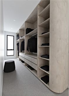 an empty walk in closet with clothes on shelves