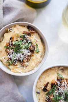 two bowls filled with mashed potatoes topped with parmesan cheese