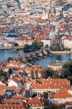 an aerial view of a city with lots of buildings and water in the foreground