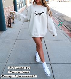 This crewneck sweatshirt is perfect for wearing out and about, lounging at home, or even layering with a jacket for added warmth! It goes with everything from jeans, to shorts, to leggings. Soft and cozy with the perfect relaxed fit and midweight fabric, it's bound to become one of your go-to favorites! ✔️ Fit: Relaxed fit, unisex. Please see size recommendations below :) ✔️ Blend: 50% cotton, 50% polyester ✔️ Preshrunk to prevent shrinking when washed ✔️ Air jet fabric for softer feel and reduc Valentine's Day Casual Long Sleeve Sweatshirt, White Crew Neck Sweatshirt For Valentine's Day, Valentine's Day Crew Neck Sweatshirt With Relaxed Fit, Cute Valentine's Day Crew Neck Sweatshirt, Valentine's Day Cotton Sweatshirt With Heart Graphic, Aesthetic Sweaters, Sweatshirt Aesthetic, Heart Sweatshirt, Valentines Outfits