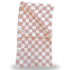 the pink and white checkered blanket is folded up