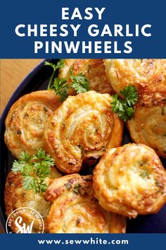 easy cheesy garlic pinwheels on a blue plate with parsley sprigs