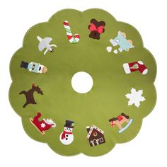 a green christmas tree skirt with various decorations on it