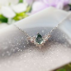 Be the best version of yourself and let your light shine with purpose and passion with our “To Bloom Again” Moss Agate White Gold Necklace. This enchanting necklace features a pear-shaped moss agate stone that sits at the heart of the silver leaves embellished with white topaz. A graceful reminder that with the right determination, nothing is beyond your means. ✦14K White Gold Vermeil (14K white gold plated over a sterling silver base) *Please be informed that your moss agate patterns are natura Moss Agate Necklace, Moss Agate Jewelry, Moss Agate Stone, Silver Leaves, White Gold Necklace, Moss Agate Ring, Gold Vermeil Jewelry, Lucky Stone, Let Your Light Shine