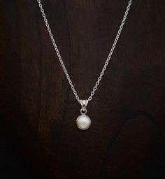 A beautiful white freshwater pearl in a simple sterling silver setting with a sterling silver 16"-18" trace chain.  Dimensions: Pearl: 8mm diameter. Pendant Length: 1.5cm including bail. Chain: 16" extendable to 18".  Materials: Sterling Silver White Freshwater Pearl  Beyond Biasa creates unique jewellery that is inspired by antique and tribal designs from around the globe. All of our pieces are handmade so please allow for slight variations in size and colour. Single Pearl Pendant, November Birthstone Necklace, Single Pearl, White Pearl Earring, Rose Quartz Earrings, Chakra Necklace, White Pearl Necklace, Blue Topaz Earrings, Chakra Jewelry