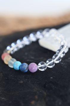 Thrive in your Quartz chakra bracelet! Wear this gorgeous bracelet every day and never forget the importance of taking care of you and your needs. Fill your cup so much it runs over and pours out into everything else you do. Quartz is the power stone that encourages crystal clarity on your path. This paired with the 7 Chakra crystals bring balanced energy across your chakras that allows you to truly thrive! AAA chakra gemstone & clear quartz beads 8mm Amethyst, Lapis Lazuli, Turquoise, Fluorite, Handmade Cheap Crystal Bracelet For Beach, Healing Mineral Crystal Bracelet, Spiritual Rainbow Crystal Bracelet With Round Beads, Rainbow Crystal Bracelet With Natural Stones For Healing, Round Hypoallergenic Crystal Bracelet For Healing, Hypoallergenic Round Crystal Bracelet For Healing, Rainbow Spiritual Bracelets With 8mm Beads, Spiritual Rainbow Bracelets With 8mm Beads, Rainbow Gemstone Beads Bracelets For Healing