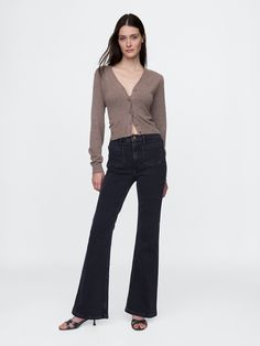 Fit: Snug & flattering through the hip & thigh with a flared leg. ​ Fabric: 87% Cotton, 12% Recycled Materials, 1% Stretch.  ​ Stretch: Stretch Jeans.  A bit of hug & a lot of hold.  Comfortable & designed to flatter.  Rise: High Rise Jeans.  Look: A four-pocket jean in a black wash.  Details: Zip fly, front & back patch pockets.  Responsibly Made: This pair of jeans is part of our water-saving Washwell program.  Compared to conventional wash methods, Washwell has saved millions of liters of water since 2016.  Our High Rise Jean has an 11" 28 cm) rise. ​ Slim through the hip & thigh.  Flared leg.  Full-length jean.  Hits below the ankle. ​ 21. 5" 55 cm) leg opening.  Inseam: Petite 30" 76 cm), Short 31" 78 cm), Regular 32" 81 cm), Long 34. 5" 88 cm), Tall 36. 5" 93 cm).  Model is approx. Black Flared Jeans Outfit, 70s Flare Jeans, Flare Jean Outfit, Black Flared Jeans, Jeans Look, Leather Jeans, Water Saving, Black Flare, Gap Pants