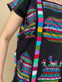 "Stunning hand-women huipil from Oaxaca, it is made in a backstrap loom. Definitely a piece of art that you can style with jeans, leather leggins, pencil skirt, etc. Made of Mexican textile. Fabric is thick. Same motif on the front and back. Fits size Medium (Maybe a Large, check measurements below) Measurements taken flat: Width 22\" Shouldet to bottom hem 26 3/4\"" Folk Style Multicolor Tops For Cinco De Mayo, Multicolor Folk Tops For Cinco De Mayo, Multicolor Tops For Cinco De Mayo Festival, Multicolor Top For Cinco De Mayo Festival, Cinco De Mayo Fiesta Blouse With Multicolor Embroidery, Multicolor Tops For Cinco De Mayo Fiesta, Traditional Blouse For Cinco De Mayo Fiesta, Mexican Textiles, Mexican Blouse