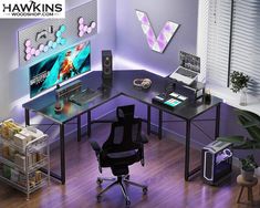 a computer desk with a monitor and keyboard on it in front of a purple wall