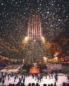 the rockefeller christmas tree in new york city is lit up with lights and people skating around it