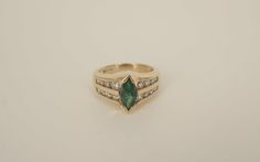 This is a Beautiful 14k yellow gold Emerald and Diamond ring.  The ring is sized at 6.25 and the band is 12.02mm wide and tapers down to 2.55mm wide at bottom center.  The marquise cut Emerald comes to approximately 1 carat and the 16 round cut diamonds come to approximately 0.75ct. **The dark spots that can be seen in some of the pictures are not on the item.  It is caused by the reflection of the camera used to take the photos.**All metal is tested with a Thermo Scientific Niton DXL precision Classic Gold Marquise Emerald Ring, Classic Marquise Emerald Ring In Gold, Heirloom Marquise Emerald Ring In 14k Gold, Formal Marquise Yellow Gold Emerald Ring, Formal Marquise Diamond Ring Stamped 14k, 14k Gold Marquise Cut Ring With Tension Setting, Elegant 14k Gold Marquise Cut Emerald Ring, Stamped 14k Marquise Cut Fine Jewelry Ring, Marquise Cut 14k Stamped Fine Jewelry Ring