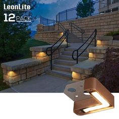 an outdoor stair light that is on the side of stairs with steps lit up at night