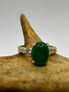 vintage green fun jade ring  Setting is a golden finished bronze setting  This is one of my hand re finished treasures. Salvaged from vintage.  Size   7 Re sizing can be done for a $20 fee and may take up to a week.  Engraving is $4 per letter.  Thank you for supporting a veteran's small business. All jewelry is shipped free within the US in a stylish gift box Emerald Jewelry With Accent Stones, Green Emerald Jewelry With Accent Stones, Green Ring With Stone Setting For May Birthstone, Emerald Green Jewelry With Accent Stones, Green Emerald Ring With Stone Setting, Oval Green Emerald Rings, Oval Green Emerald Ring For May Birthstone, Green Ring With Diamond Accents Gift, Emerald Jewelry With Diamond Accents In Green