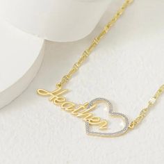 Show your love and appreciation with this stunning custom heart name pendant. This pendant features a two tone design of 10k vermeil gold and sterling silver, creating a beautiful contrast and a unique look. The pendant is shaped like a heart, with a cut-out of your chosen name in the center. The name is also plated with 10k vermeil gold, adding a touch of elegance and sparkle. The pendant comes with a 10k gold 18 inch matching chain, making it ready to wear or gift. This pendant is a perfect wa Gold Heart-shaped Name Jewelry, Heart-shaped Gold Jewelry With Names, Custom Name Heart Necklace For Valentine's Anniversary, Customized Yellow Gold Heart Pendant Name Necklace, Gold Heart Necklace With Name For Mom, Gold Double Heart Name Necklace With Charm, Gold Heart Pendant Name Necklace, Heart Charm Nameplate Necklace For Anniversary Gift, Customized Gold Double Heart Necklace