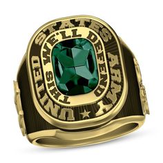 a gold ring with a green stone in the center and words written below it, on a white background