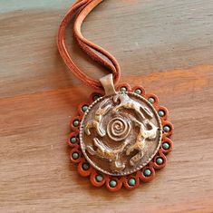 An artisan crafted fine pewter pendant featuring a circle of running horses is paired with a hand stamped and painted leather concho to create this stunning necklace.... pendant graces your neck on a double 16 inch length of deerskin leather ... clasp is sterling silver.  Length of leather is 16 inches, total length with clasp is approx. 17 inches.  Pendant diameter is 1 3/4 inches.  All Heart of a Cowgirl designs arrive packaged in a hand stamped muslin bag, perfect for gift giving. See more designs in my Etsy shop: www.HeartofaCowgirl.etsy.com   AN ORIGINAL DESIGN BY HEART OF A COWGIRL Nickel Free Southwestern Style Round Necklace, Handmade Southwestern Medallion Necklaces, Southwestern Style Hand Tooled Necklace As Gift, Southwestern Style Round Pendant Necklace, Artisan Stamped Round Pendant Necklace, Unique Adjustable Stamped Necklace, Stamped Bronze Round Pendant Jewelry, Bohemian Stamped Round Pendant Jewelry, Bohemian Stamped Round Pendant Necklace