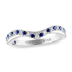 a white gold ring with blue sapphires and diamonds on the band, set in 18k white gold