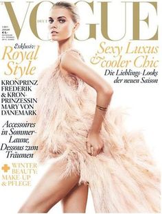 a woman in a feathered dress on the cover of a magazine