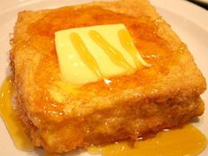 a piece of french toast topped with butter and syrup