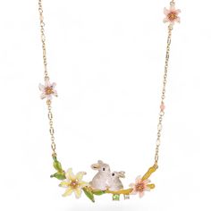 a necklace with flowers and an animal on it