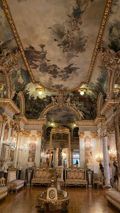 an ornately decorated room with couches and paintings on the ceiling