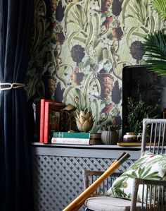 a living room with wallpaper and chairs