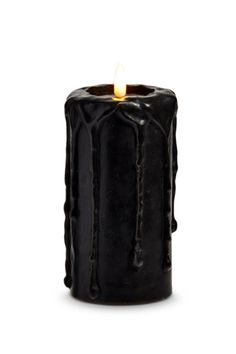 a black candle that is lit on a white background