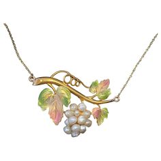 THIS IS ONE OF THE MOST BEAUTIFUL ANTIQUE ENAMEL JEWELS WE HAVE SEEN. THE VICTORIAN - ART NOUVEAU PENDANT NECKLACE IS IN THE FORM OF A CLUSTER OF GRAPES HANGING FROM THE VINE. THE GRAPES ARE A CLUSTER OF WHITE PEARLS. THE GRAPE LEAVES ARE ADORNED WITH EXQUISITE IRIDESCENT ENAMEL IN THE MOST BEAUTIFUL COLORS WITH GREENS, YELLOWS AND PINK HUES. THE SPECTACULAR DETAILED ENAMEL IS OF THE HIGHEST QUALITY. THE PENDANT DATES TO C1880-1910. The grape leaves and vine are fully modeled with wonderful thre Grape Vine Jewelry, Gold Orchid, Accessory Design, Art Nouveau Flowers, Art Nouveau Pendant, Nouveau Jewelry, Necklaces Pendant, Gold Link Chain, Necklace Antique