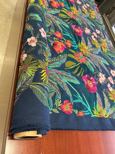 the blue fabric has colorful flowers on it