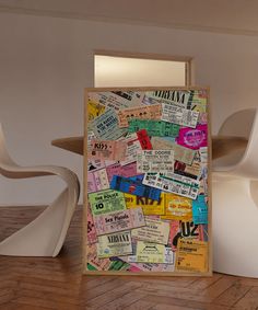 a wooden frame covered in lots of different types of tickets on the inside of it