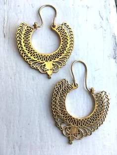 handcast in India, intricate style brass earrings statement piece that spices up any plain outfit at work, or out on the town Intricate Brass Hoop Earrings, Ornate Gold Brass Chandelier Earrings, Traditional Bronze Pierced Earrings, Antique Gold Brass Jewelry With Intricate Design, Gold Drop Earrings With Antique Finish, Festive Bronze Brass Jewelry, Ornate Handmade Brass Hoop Earrings, Traditional Pierced Brass Earrings, Festive Brass Pierced Plug Earrings