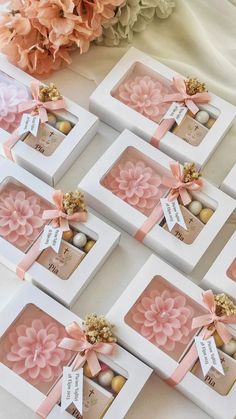 six small boxes with pink flowers in them