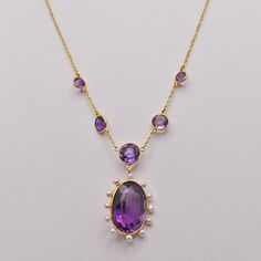 Key Features: * Material: Solid 14K Yellow Gold * Total Weight: 7.1 grams * Amethyst: Natural amethyst, featuring a center 12CT oval amethyst and a total carat weight of 4.52CT accent amethysts in chain. * Chain: 16 inch 14K yellow gold cable chain * Pendant: Measures 1 inch in length and features a 12 Freshwater Pearl halo.  * Elegant Design: Ideal for special occasions or as a unique gift for someone special. * Gift-Ready: Comes with a complimentary jewelry gift box, making it ready for giftin Elegant Evening Cabochon Necklaces, Elegant Yellow Gold Amethyst Necklace, Classic Amethyst Pendant Necklace, Classic Amethyst Necklaces For Wedding, Classic Yellow Gold Necklaces With Cabochon, Luxury Amethyst Necklace For Formal Occasions, Formal Yellow Gold Amethyst Necklace, Fine Jewelry Oval Necklace With High Luster, Elegant Purple Necklace With Polished Finish