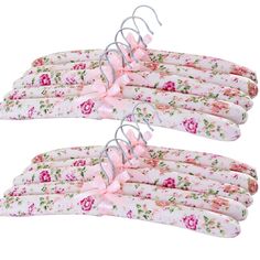 four pink flowered clothes hangers with bows on the ends and ties attached to them