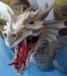 a close up of a dragon head on a wall