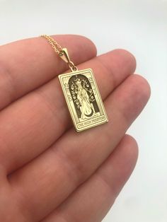 Elevate your spiritual style with our exquisite 14K Massif Gold Tarot Necklace featuring The High Priestess Card. Meticulously handcrafted, the rectangular pendant embodies the mystique of tarot symbolism, making it a unique and meaningful addition to your jewelry collection. This spiritual necklace serves as a powerful statement piece, blending craftsmanship with mysticism. An ideal gift for women who appreciate the fusion of elegance and spirituality, this handmade necklace captures the essenc Spiritual Rectangular Jewelry For Good Luck, Rectangular Spiritual Jewelry For Good Luck, Rectangular Spiritual Good Luck Jewelry, Spiritual Rectangular Good Luck Jewelry, Spiritual Good Luck Rectangular Pendant Jewelry, Tarot Symbolism, Mystic Jewelry, Tarot Necklace, Spiritual Style